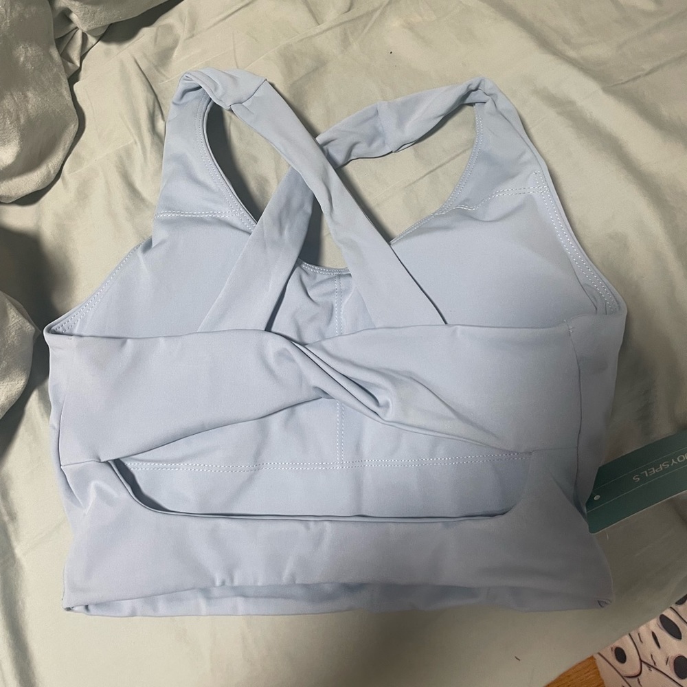 Blue workout tank top with cross over back detail.Brand New!